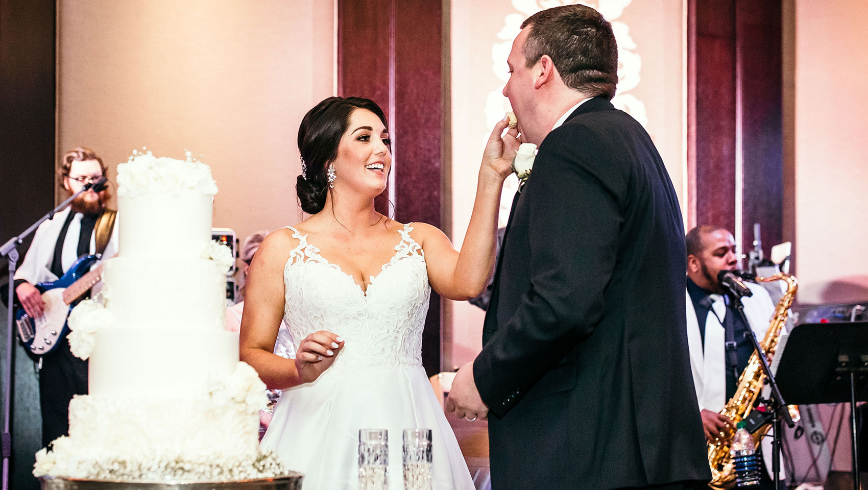 Bride feeds cake to groom
