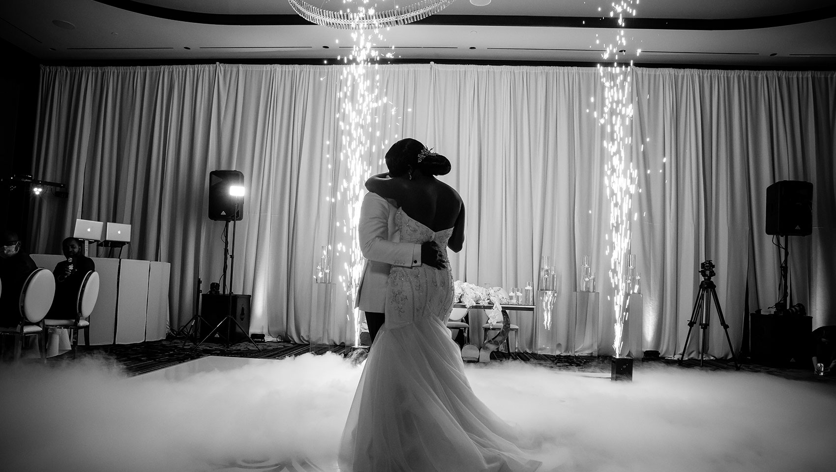 Couple dancing at reception in front of sparklers