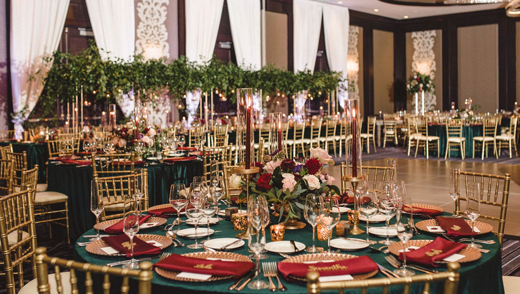 wedding reception tables set up with flowers in ballroom at Kimpton Tryon Park Hotel