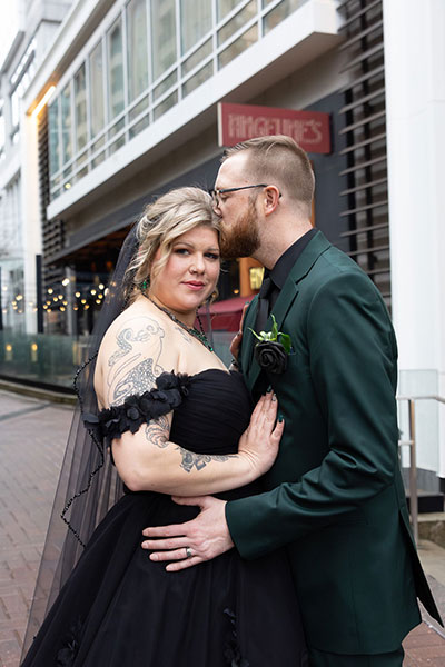 newlyweds in front of hotel