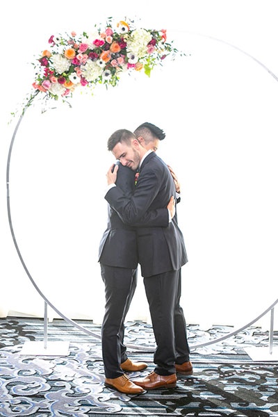 couple standing under their hoopa.
