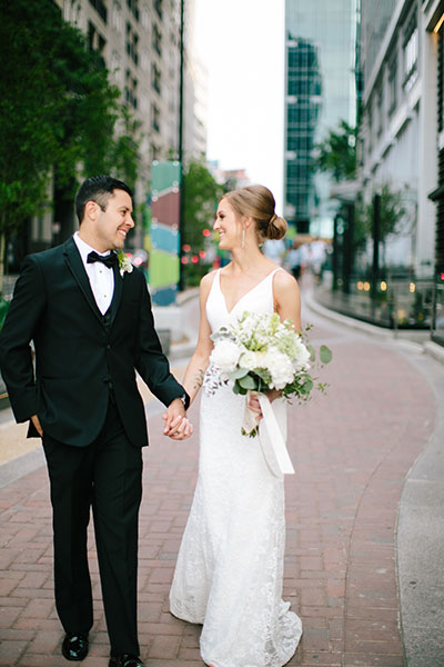 bride and groom walking outside of hotel